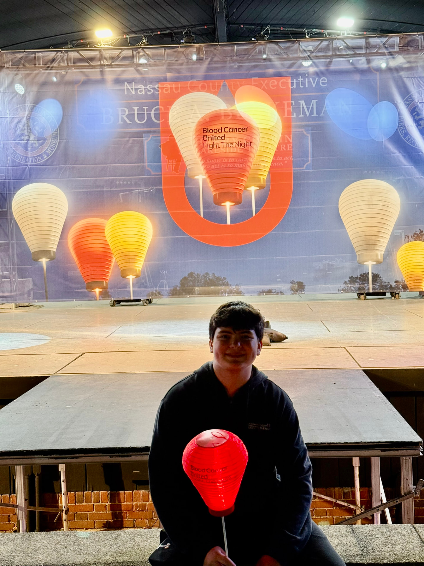 Gabriel Jaffe holding a red lantern at the Blood Cancer United Light The Night Walk