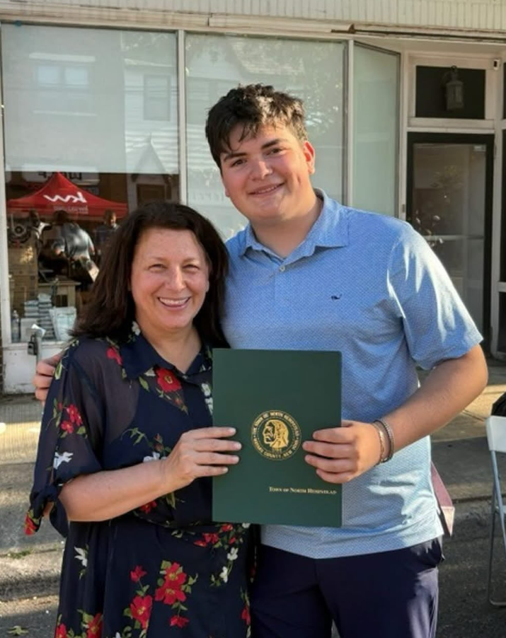 Gabriel Jaffe with Councilwoman Marianne Dalimonte holding a Town of North Hempstead proclamation